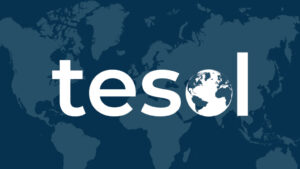Alt Text The word "tesol" in bold white lowercase letters with a globe icon integrated into the letter "o," set against a dark blue world map background.